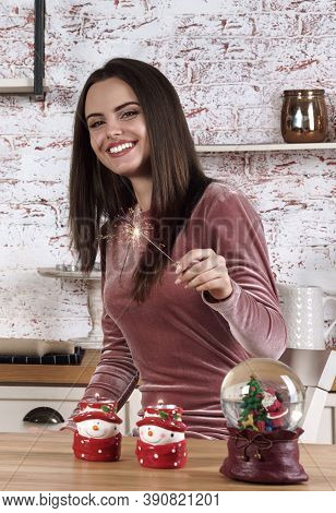 Young Woman Holding Sparker Stick And Celebrating New Year At Home