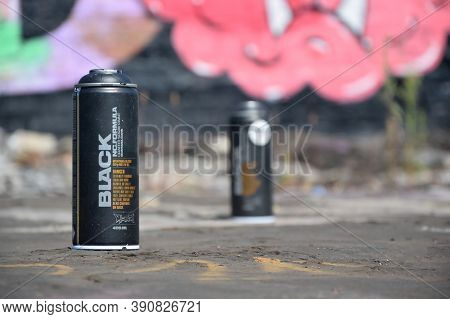 Used Montana Black Aerosol Spray Cans Against Graffiti Paintings. Mtn Or Montana-cans Is Manufacture