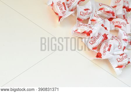 Raffaello Candies On Beige Background. Raffaello Is A Spherical Coconut Almond Confection That Itali
