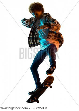 one cauacsian young man skateboarder Skateboarding in studio silhouette shadow isolated on white background
