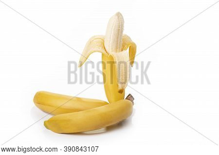 Shooting In The Studio. A Branch Of Ripe Yellow Bananas In A Peel. On White Background. Close-up