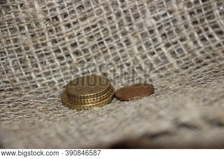Some Euro Coins On Burlap Canvas Background. Little Money Concept. Powerty Concept