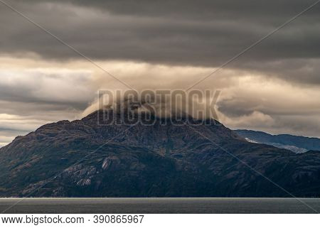 Sarmiento Channel, Chile - December 11, 2008: Amalia Glacier And Fjord. Brown Cloudscape Descends An