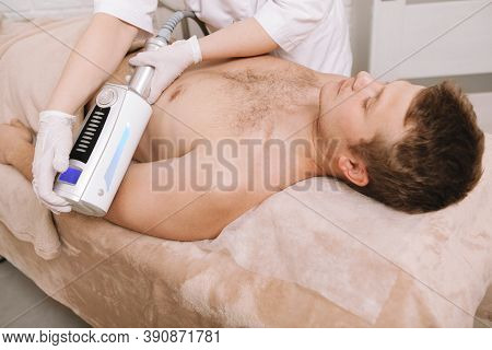 Unrecognizable Cosmetologist Massaging Arm Of A Male Client Using Endospheres Massage Apparatus