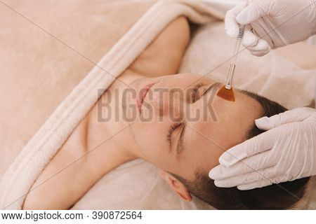Close Up Of A Cosmetologist Applying Moisturizer On The Skin Of Male Client