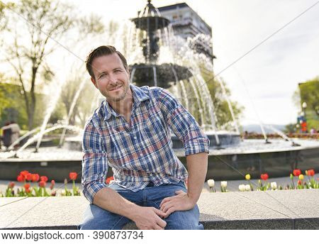 A Nice Tourist Man With Tourny Fountain On The Back