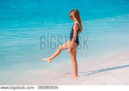 Adorable Active Little Girl At Beach During Summer Vacation