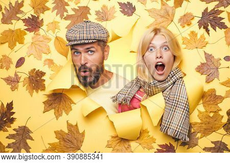 Surprised Couple On Autumn Clothes Discounts, Man With Beard And An Attractive Girl In Yellow Backgr