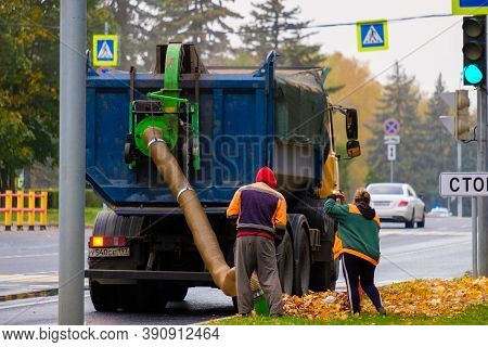 Moscow. Russia. October 11, 2020. Utility Workers Remove Yellow Autumn Leaves With An Industrial Vac