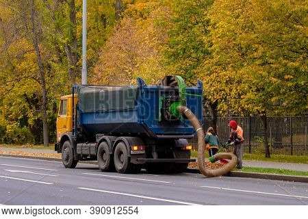 Moscow. Russia. October 11, 2020. Utility Workers Remove Yellow Autumn Leaves With An Industrial Vac