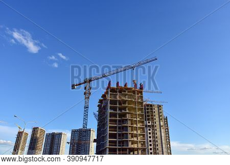Preparing To Pour A Bucket Of Concrete Into Formwork.tower Crane Lifting Cement Bucket During Constr