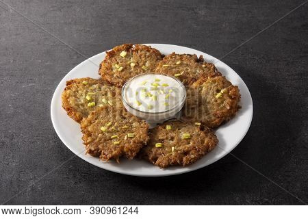Traditional Jewish Latkes Or Potato Pancakes On Black Background