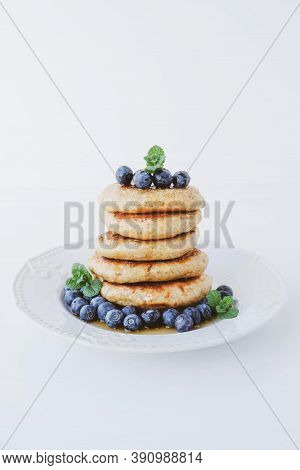 Stack Of Homemade Small Thick Pancakes Served With Fresh Blueberries.