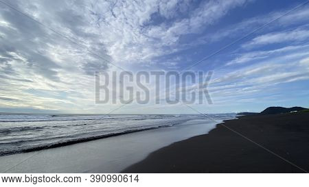 Black Volcanic Sand Beach. Beautiful Blue Sea. Khalaktyrsky Beach, Kamchatka Peninsula. Waves Roll I