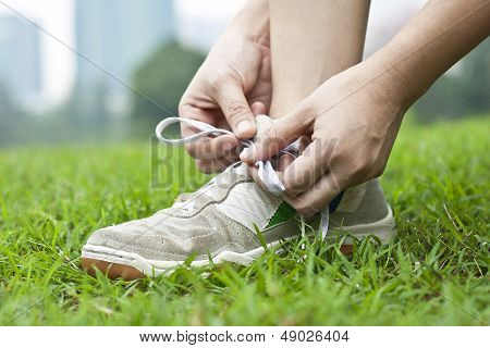 Runner tying running shoes getting ready for jogging