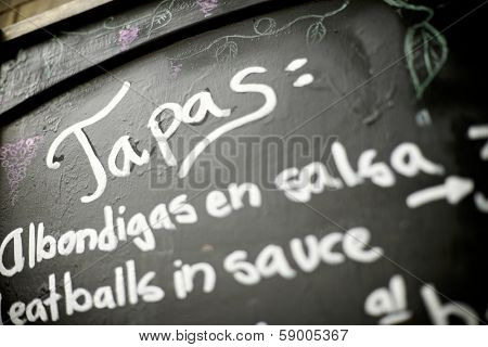foreground of a  poster of the menu in a typical Spanish restaurant, Sevilla, Andalusia, Spain