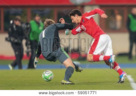 VIENNA,  AUSTRIA - MARCH 22 Philipp Hosiner (#20 Austria) and Gunnar Nielsen (#1 Faroe Islands) fight for the ball during the world cup qualifier game on March 22, 2013 in Vienna, Austria.