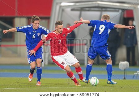 VIENNA,  AUSTRIA - MARCH 22 Marko Arnautovic (#7 Austria) and Hallur Hansson (#6 Faroe Islands) fight for the ball during the world cup qualifier game on March 22, 2013 in Vienna, Austria.