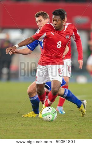 VIENNA,  AUSTRIA - MARCH 22 David Alaba (#8 Austria) and Frodi Benjaminsen (#7 Faroe Islands) fight for the ball during the world cup qualifier game on March 22, 2013 in Vienna, Austria.
