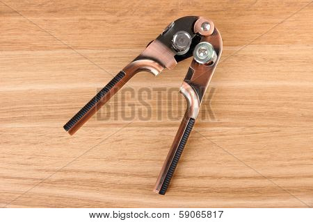 Can piercer on wooden background
