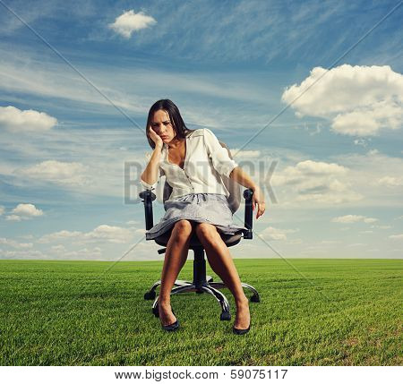 doleful businesswoman sitting on the office chair at outdoors