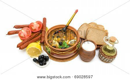 Dish Of Russian Hodgepodge Soup In Ceramic Pot And Other Foodstuffs On White Background