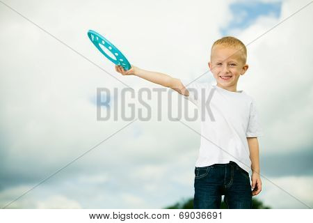 Child In Playground Kid In Action Boy Playing With Frisbee