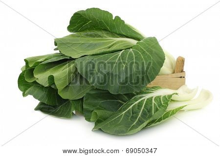 fresh chinese paksoi in a wooden crate on a white background
