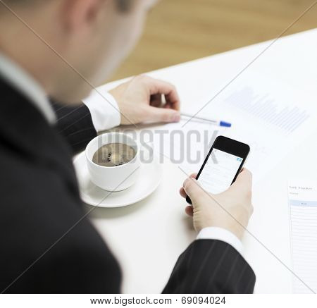 business, technology and interent concept - businessman with smartphone reading news