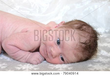 Infant laying on belly