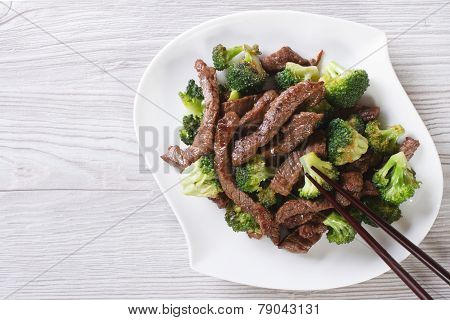 Asian Beef With Broccoli And Chopsticks. Horizontal Top View