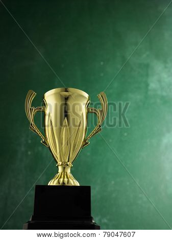 gold trophy against black board