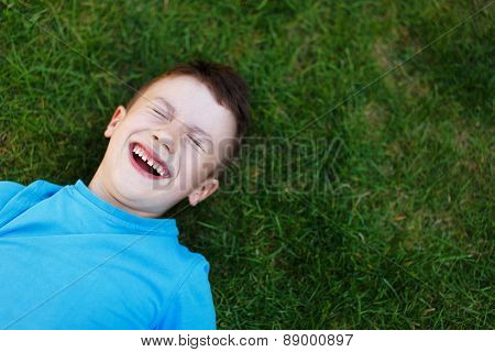 Little Boy Laughing In Grass