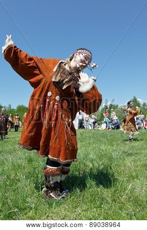 Girl In Clothing Aborigine Of Kamchatka Dancing On The Green Grass. Kamchatka, Russia
