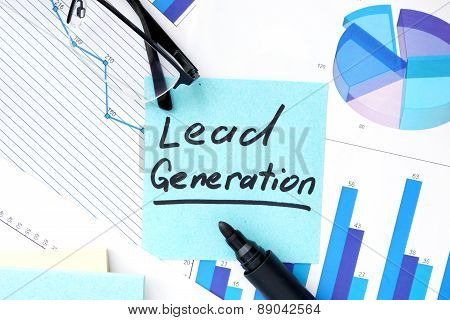 Papers with graphs, glasses and Lead Generation concept.