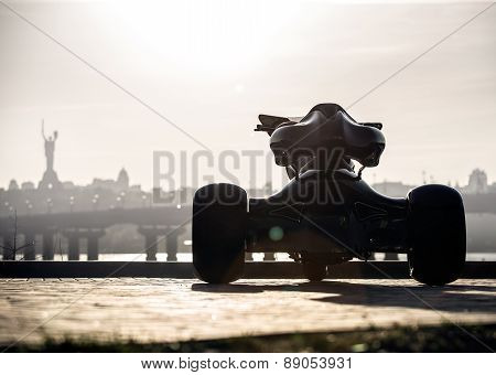 Black trike standing on the light street