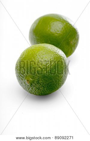 Limes on white background - close-up