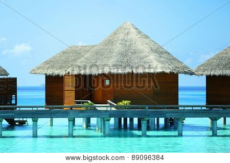 Water villas over blue ocean in Baros Maldives