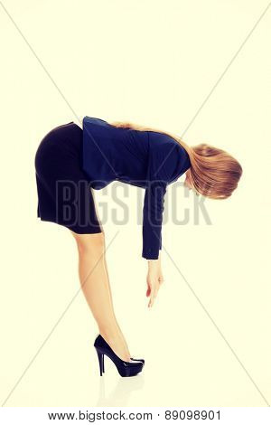 Young business woman bend down