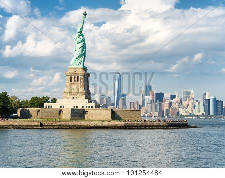 The Statue of Liberty with the New York skyline on the background on a beautiful summer day