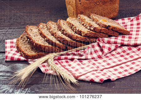 Slices Of Bread With Spikelet Of Wheat On A Cloth On A Boards