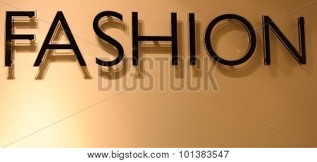 Black Text Fashion Casting Shadow On Gloden Background
