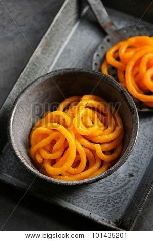 Jilebi Selective focus - Indian Sweet on a rustic background