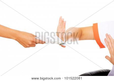 Young woman doctor refusing bribe.