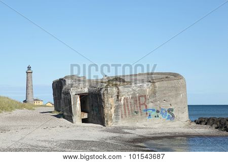 The beach in Skagen with an old bunker and the grey lighthouse