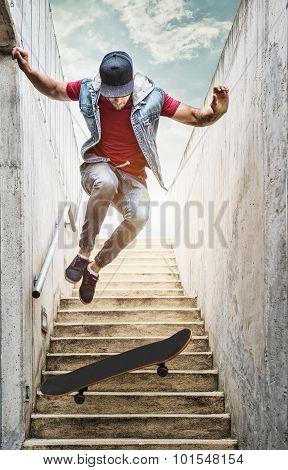 Professional skateboarder boy jumps off the stairs