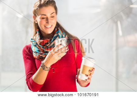 Woman at Fountain with Phone and coffee to takeaway