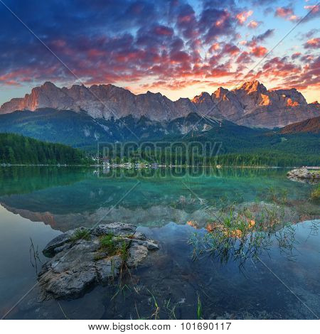 Fantastic sundown on mountain lake Eibsee, located in the Bavaria, Germany. Dramatic unusual scene. Alps, Europe.