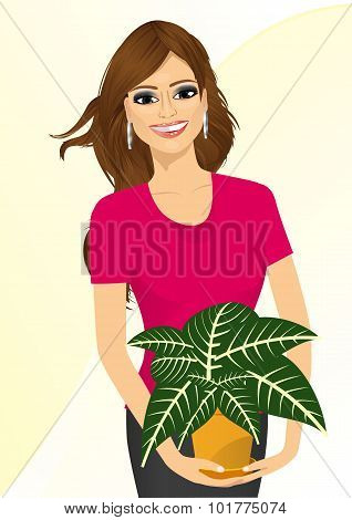 woman holding sanchezia plant