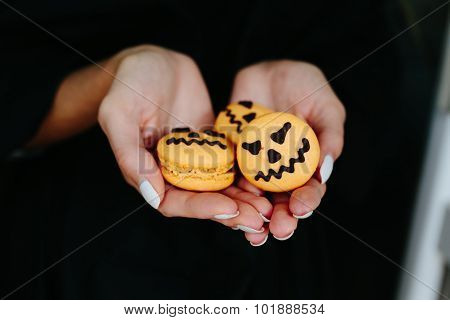 woman holding a biscuit for Halloween